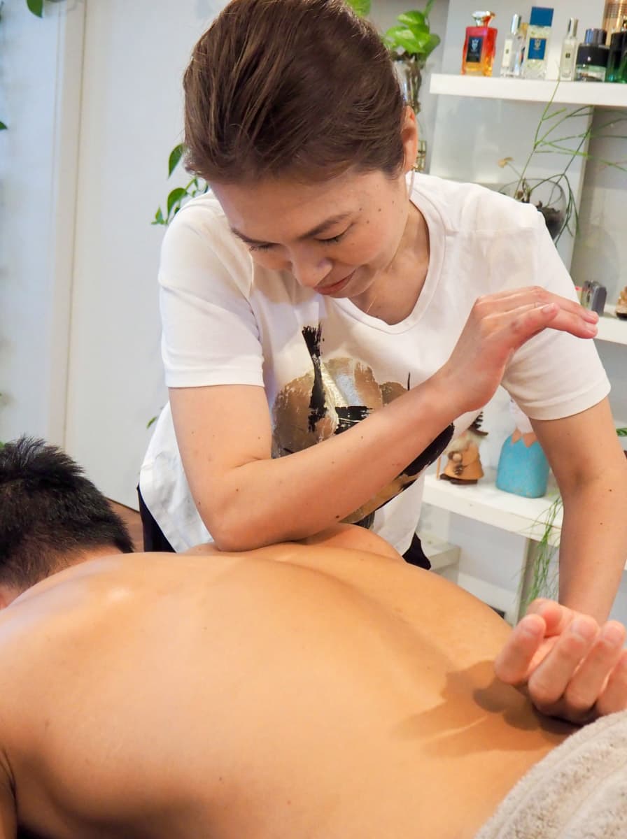 Ayako Lovett performing remedial massage on a client